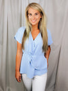Top features a solid base color, short cuffed sleeves, V-neck line, front twist detail and runs true to size!-light blue