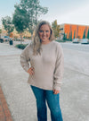 Sweater features a taupe color, long sleeves, round neck line, horizontal line detailing, soft material and runs true to size! 