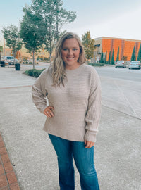 Sweater features a taupe color, long sleeves, round neck line, horizontal line detailing, soft material and runs true to size! 