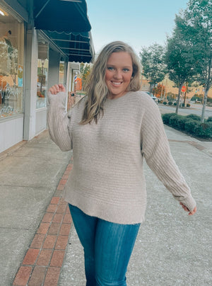 Sweater features a taupe color, long sleeves, round neck line, horizontal line detailing, soft material and runs true to size! 