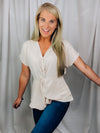 Top features a solid base color, short cuffed sleeves, V-neck line, front twist detail and runs true to size!-oatmeal