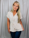 Top features a solid base color, short cuffed sleeves, V-neck line, front twist detail and runs true to size!-oatmeal
