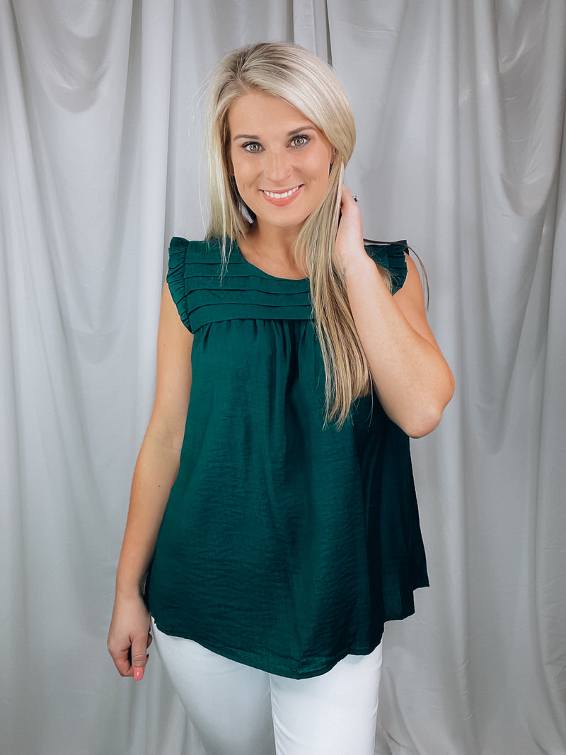 Top features a solid base color, sleeveless detail, round neck line, detailing on the chest, lightweight material and runs true to size!-hunter green