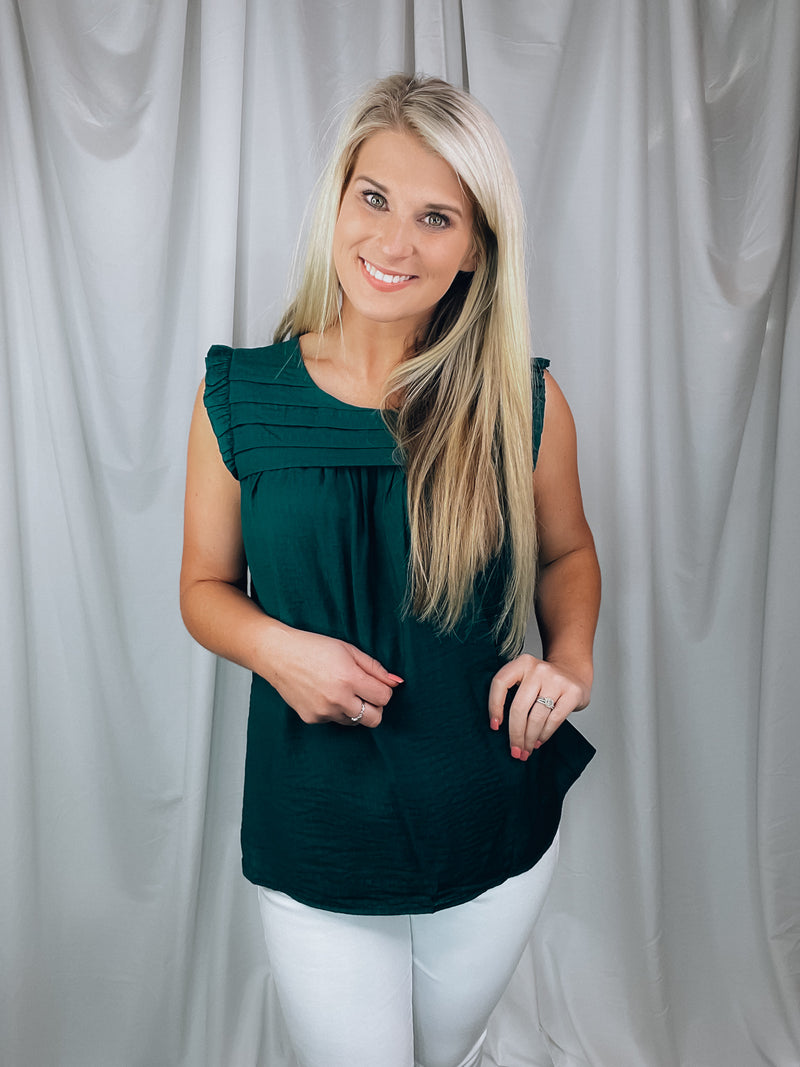 Top features a solid base color, sleeveless detail, round neck line, detailing on the chest, lightweight material and runs true to size!-hunter green