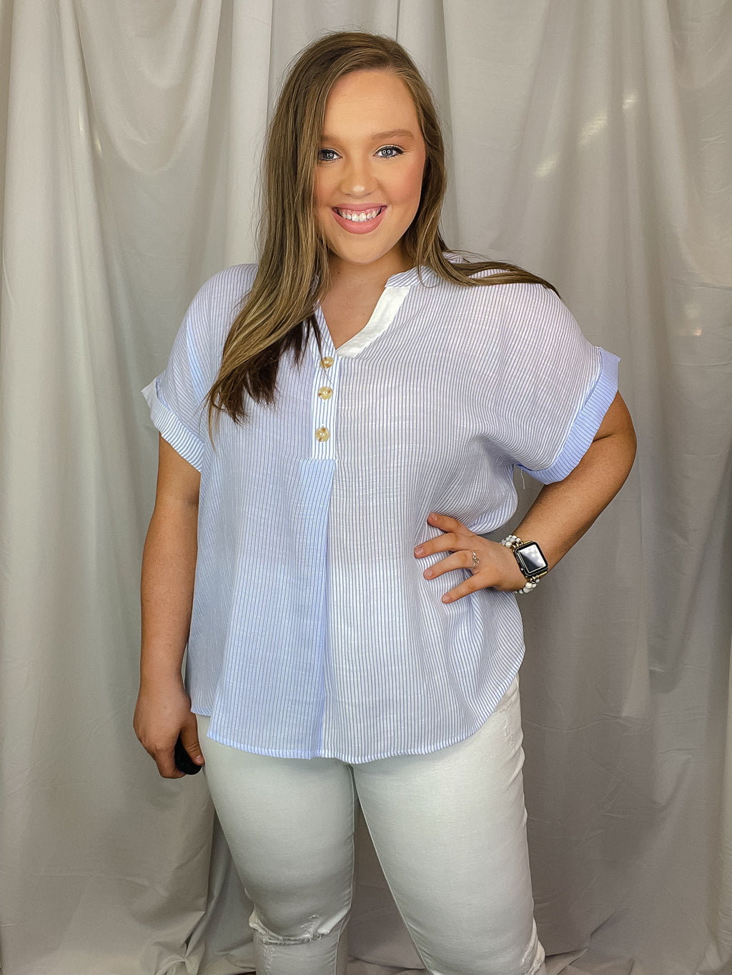 Top features a blue base, white pin stripe detail, V-neck line, cuffed short sleeves and runs true to size!   Materials:  63% Rayon / 37% Polyester 