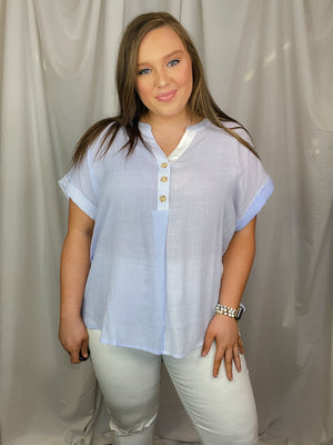 Top features a blue base, white pin stripe detail, V-neck line, cuffed short sleeves and runs true to size!   Materials:  63% Rayon / 37% Polyester 