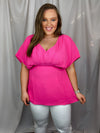 Top features a solid base color, V-neck line, dolman sleeves, pleated detailing and runs true to size!-pink