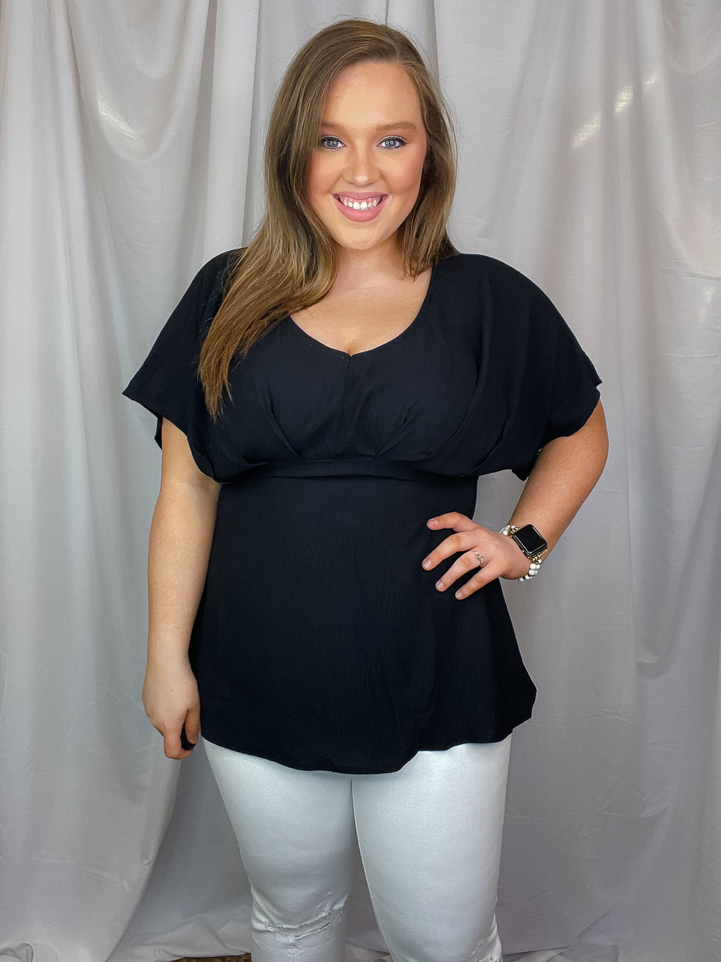 Top features a solid base color, V-neck line, dolman sleeves, pleated detailing and runs true to size!-black