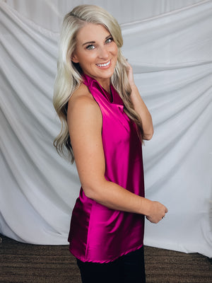 Top features a silky material, halter button closure neck line, sleeveless detail, backless detail, slight cowl neck and runs true to size!-MAGENTA