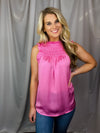 Top features a solid base color, sleeveless detail, smocked detail, ruffle detailing and runs true to size!-pink