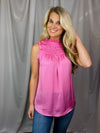Top features a solid base color, sleeveless detail, smocked detail, ruffle detailing and runs true to size! -pink