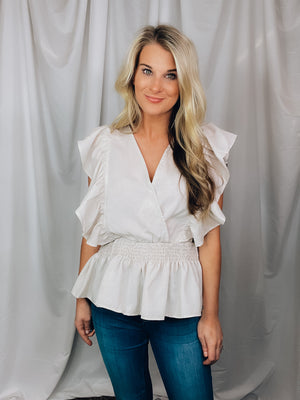 Top features a cream base, V-neck line, short sleeves, peplum hem and runs true to size! 