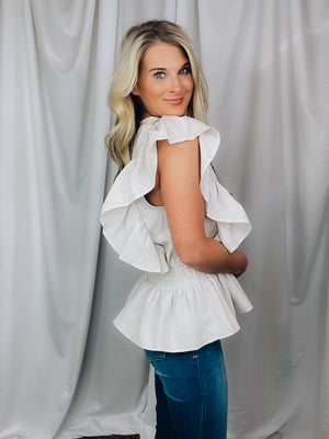 Top features a cream base, V-neck line, short sleeves, peplum hem and runs true to size! 