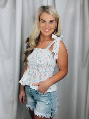 Top features a cream base, pink, blue, green floral print, sleeveless detail, fit and flare bottom, cropped length, square neck line and runs true to size! 
