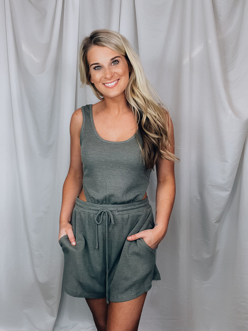 Romper features a dark olive color, soft waffle thermal material, short sleeves, elastic waist, cut-out back detail and runs true to size! PERFECT because you can wear your normal bra with this bad boy and still show some unique flattering cut outs. 