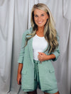 Linen Blazer features a 3/4 roll-sleeve, a base color with a functioning front button and collar detail, lined in gingham fabric. Fits true to size!-sage