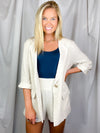 Linen Blazer features a 3/4 roll-sleeve, a base color with a functioning front button and collar detail, lined in gingham fabric. Fits true to size!-oatmeal