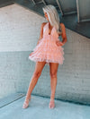 Tulle dress features a base color with a deep V cut-out, adjustable tie detail around the neck, and elastic waistband with an open back. Runs true to size!-pink
