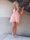 Tulle dress features a base color with a deep V cut-out, adjustable tie detail around the neck, and elastic waistband with an open back. Runs true to size!-pink
