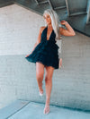 Tulle dress features a base color with a deep V cut-out, adjustable tie detail around the neck, and elastic waistband with an open back. Runs true to size!-black