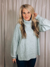 Sweater features a solid base color, heather multi color dot detailing, long sleeves, turtle neck line, side hem slits, and runs true to size!-light blue