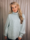 Sweater features a solid base color, heather multi color dot detailing, long sleeves, turtle neck line, side hem slits, and runs true to size!-light blue