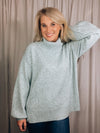 Sweater features a solid base color, heather multi color dot detailing, long sleeves, turtle neck line, side hem slits, and runs true to size!-light blue