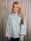 Sweater features a solid base color, heather multi color dot detailing, long sleeves, turtle neck line, side hem slits, and runs true to size!-light blue