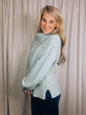 Sweater features a solid base color, heather multi color dot detailing, long sleeves, turtle neck line, side hem slits, and runs true to size!-light blue