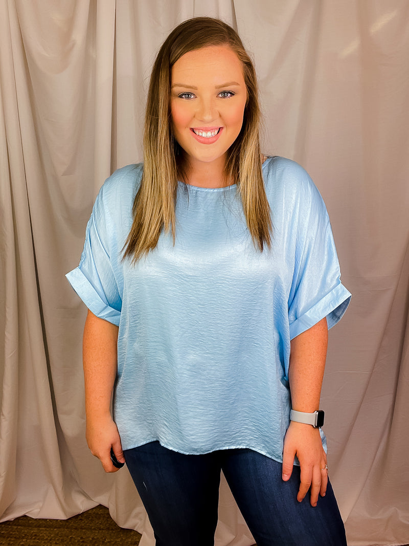 Top features a soft silk material, round neck line, short sleeves, oversized fit and runs true to size!-sky