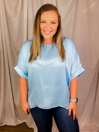 Top features a soft silk material, round neck line, short sleeves, oversized fit and runs true to size!-sky