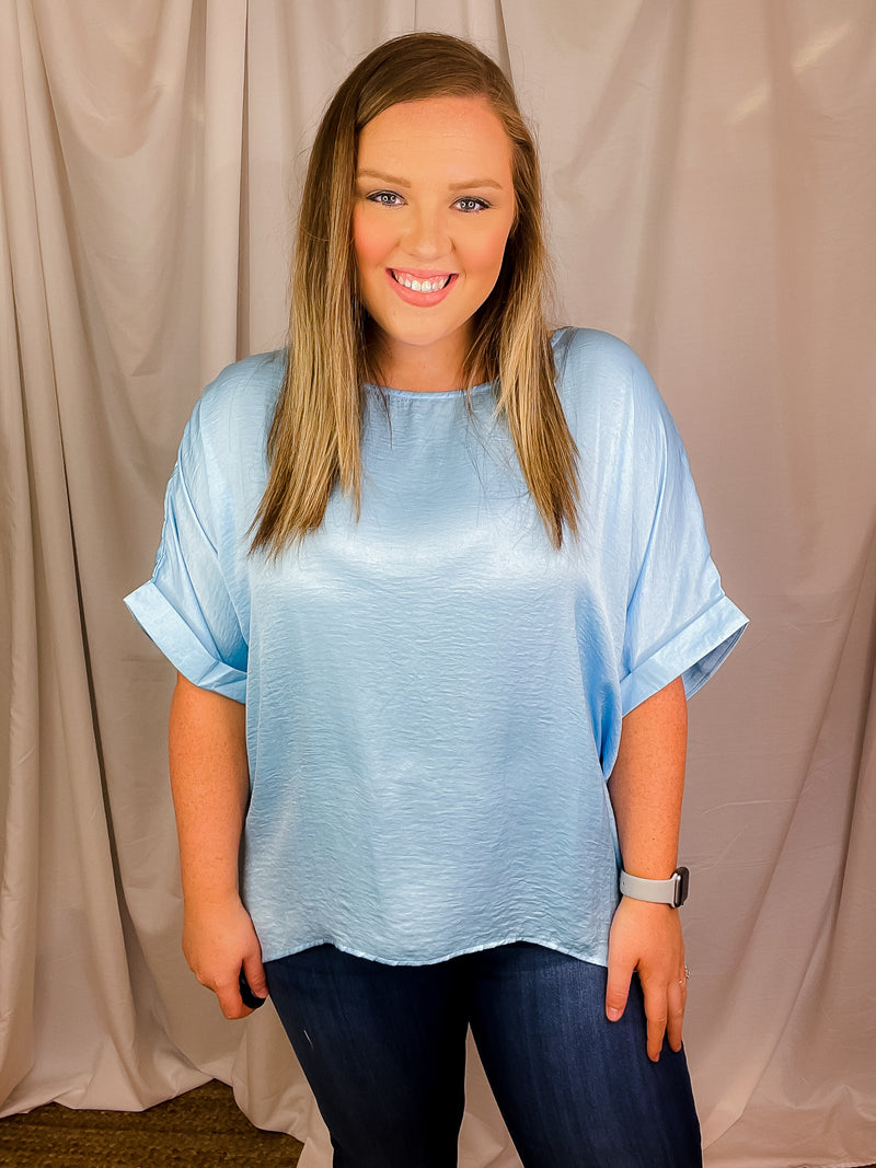 Top features a soft silk material, round neck line, short sleeves, oversized fit and runs true to size!-sky