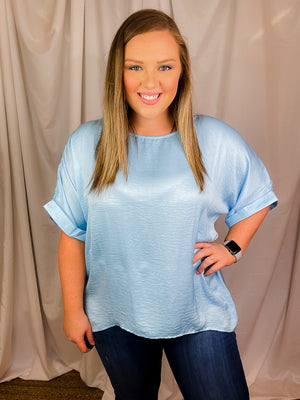 Top features a soft silk material, round neck line, short sleeves, oversized fit and runs true to size!-sky