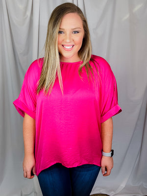 Top features a soft silk material, round neck line, short sleeves, oversized fit and runs true to size!-magenta