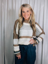 Sweater features a taupe base, multi colored striped print, long sleeves, round neck line and runs true to size! 