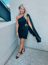 Black satin dress features subtle floral design, side cutout, with a draped, one shoulder detail. Runs true to size!  - Jacquard print - Draped one shoulder - Side ruffle detail - Pleated - Side zipper - 100% Polyester - Lined