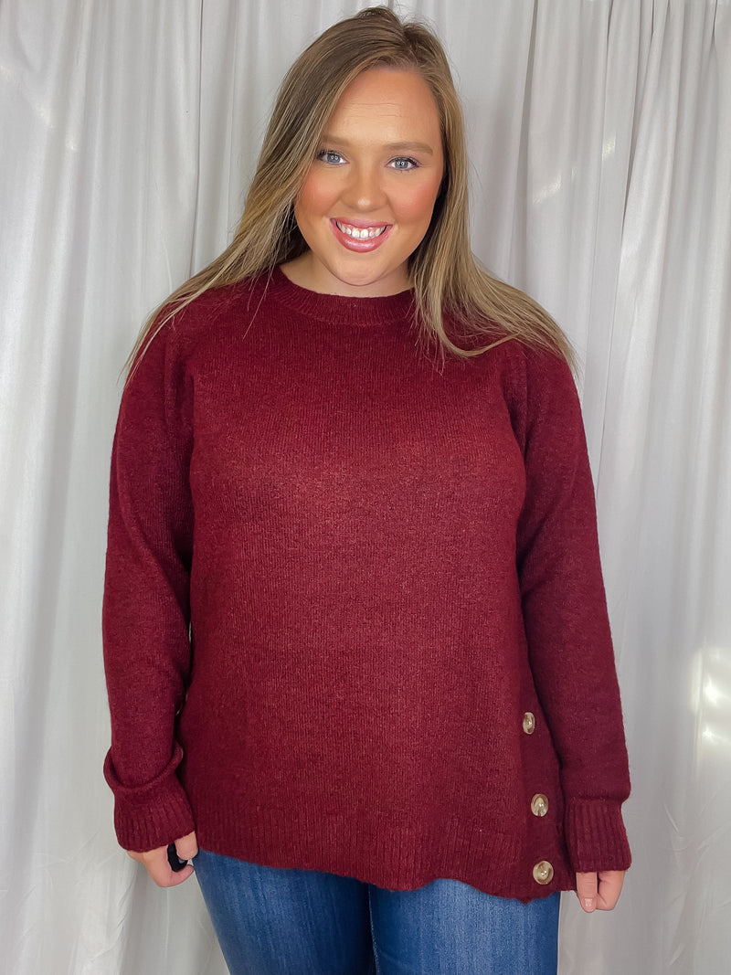 Top features a solid base color, long sleeves, round neck line, soft material, side hem button detail and runs true to size!-oatmeal