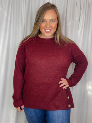 Top features a solid base color, long sleeves, round neck line, soft material, side hem button detail and runs true to size!-burgundy