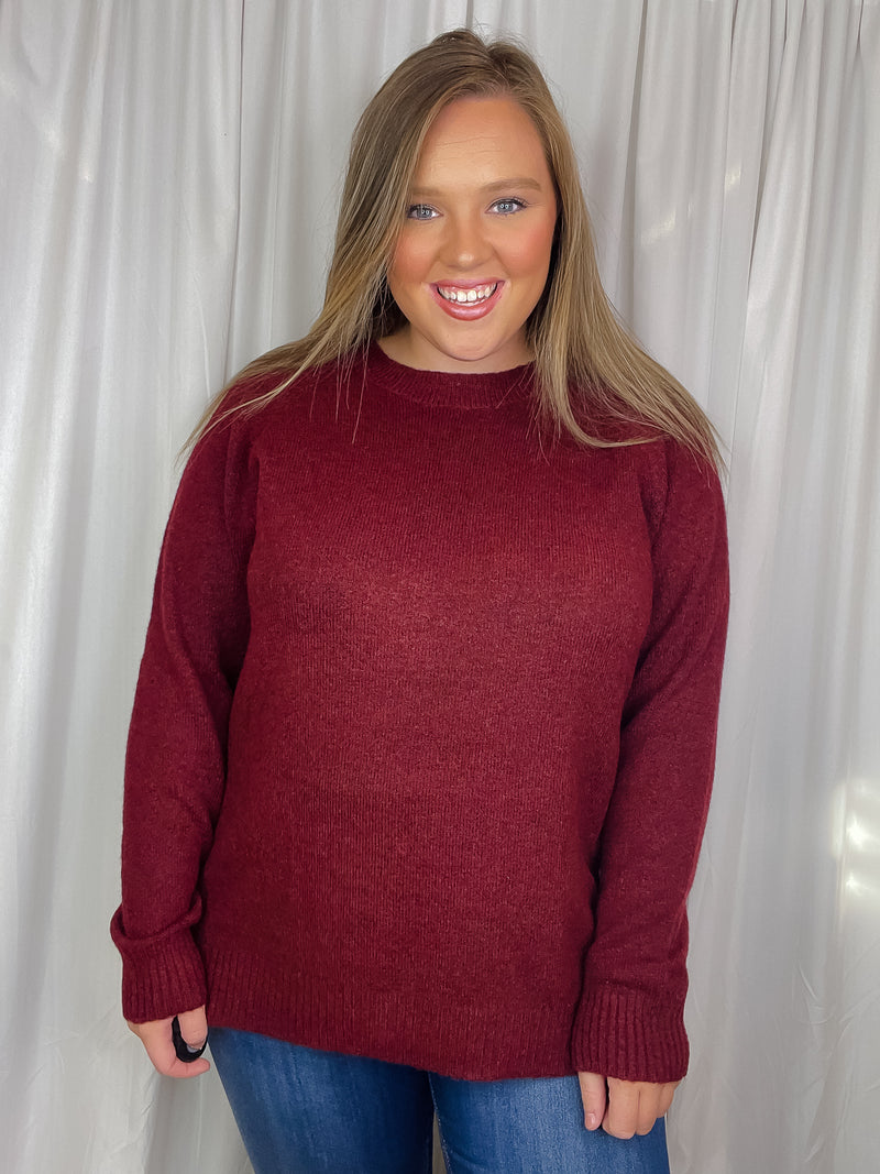 Top features a solid base color, long sleeves, round neck line, soft material, side hem button detail and runs true to size!-burgundy