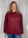 Top features a solid base color, long sleeves, round neck line, soft material, side hem button detail and runs true to size!-burgundy