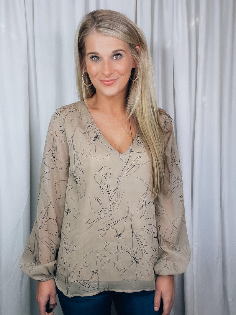 Top features a taupe base, black floral print, underlining, long sleeves, V-neck line, and runs true to size! 