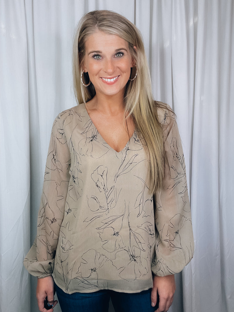 Top features a taupe base, black floral print, underlining, long sleeves, V-neck line, and runs true to size! 