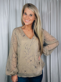 Top features a taupe base, black floral print, underlining, long sleeves, V-neck line, and runs true to size! 