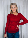 Top features a solid base color, long sleeve, asymmetrical neck line, and runs true to size!-red