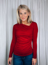 Top features a solid base color, long sleeve, asymmetrical neck line, and runs true to size!-red