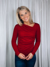Top features a solid base color, long sleeve, asymmetrical neck line, and runs true to size!-red