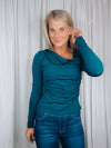 Top features a solid base color, long sleeve, asymmetrical neck line, and runs true to size!-teal