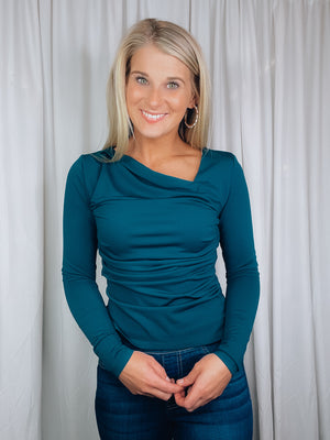 Top features a solid base color, long sleeve, asymmetrical neck line, and runs true to size!-teal