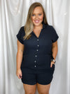 Romper features a soft light weight material, short sleeve detail, button down front detail, collar detail and runs true to size! -black