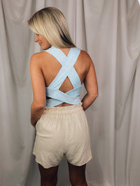 Bodysuit features a heathered light blue color, square neck line, sleeveless detail, cross-open back detail, snap bottom closure, fitted fit and runs true to size! 